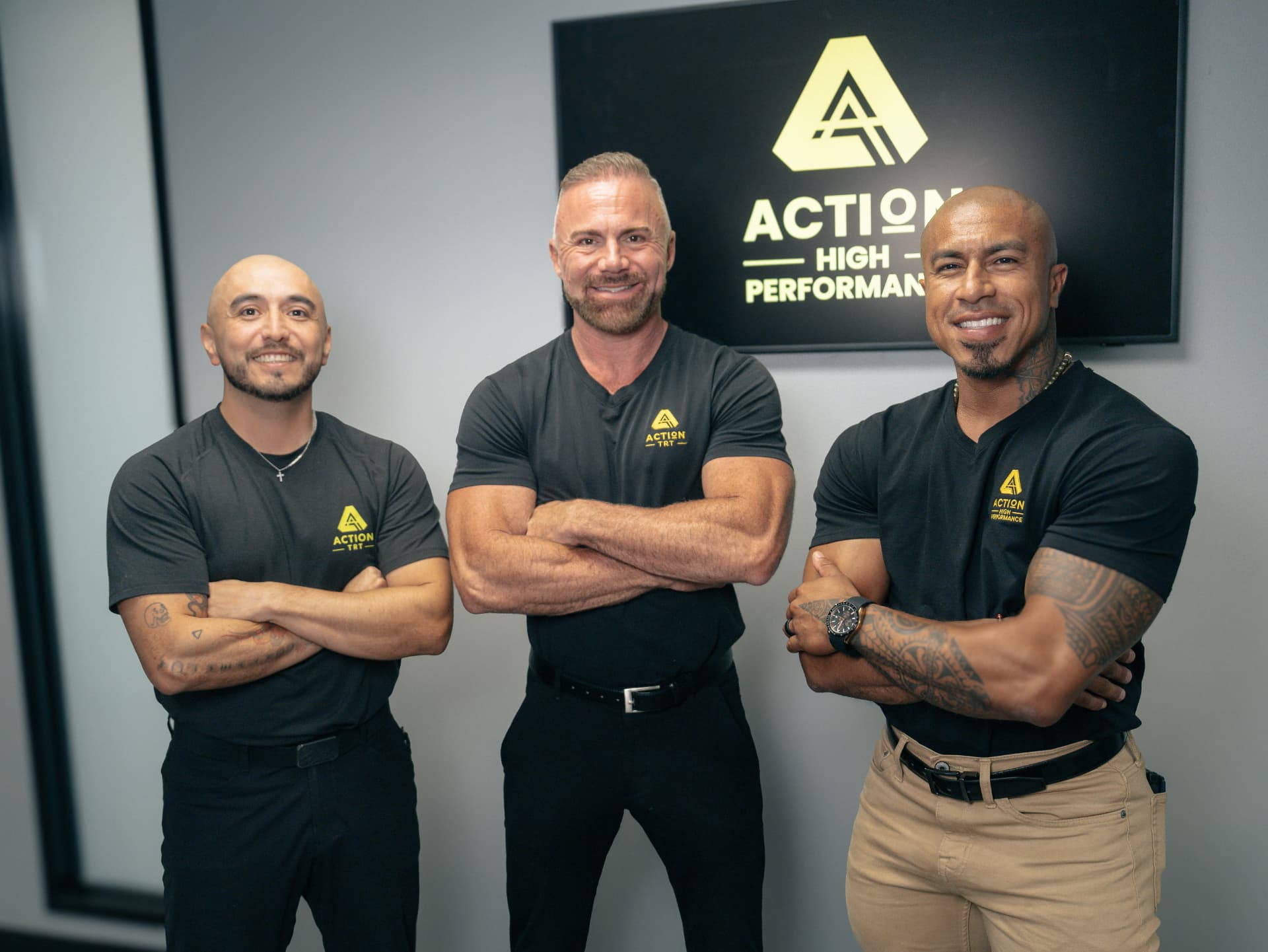 Tyler Stanley with two members of the Action TRT team in the clinic